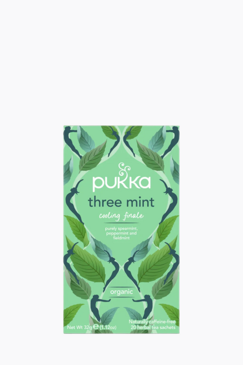 A package of Pukka Three Mint Organic Tea with a green and white color scheme and leaf patterns.