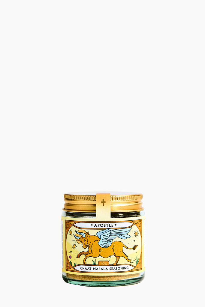 Jar of Chait Masala Seasoning with a gold lid on a white background