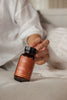 Hand holding a supplement bottle labeled 'Blends' Iconic Iron