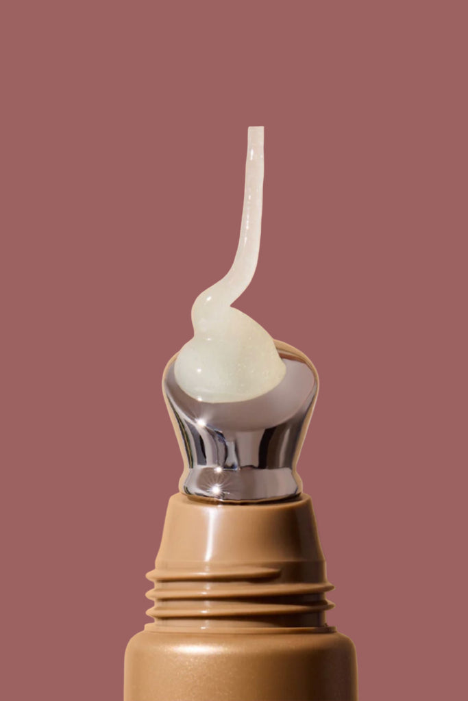 Brown bottle with a white cap on a beige background