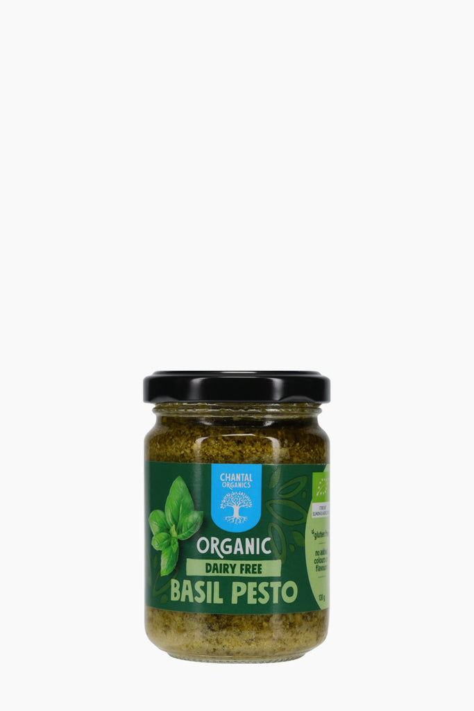 Jar of organic basil pesto on a white background