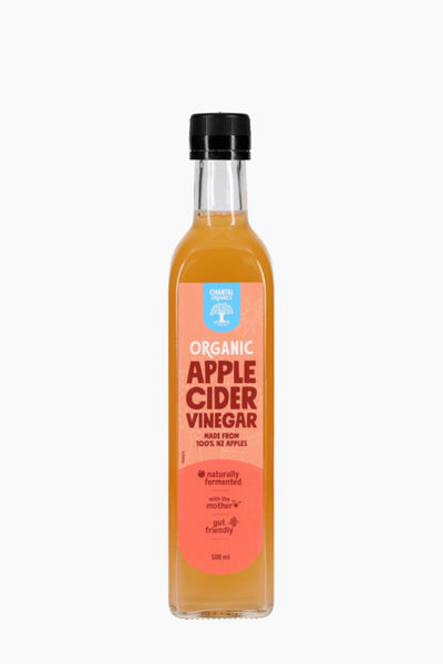 Bottle of organic apple cider vinegar on a white background