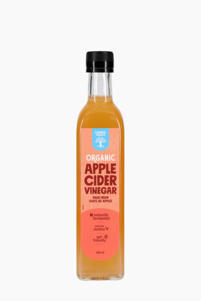 Bottle of organic apple cider vinegar on a white background