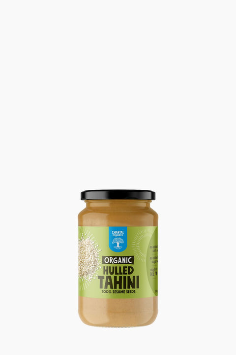 Jar of organic hulled tahini on a white background