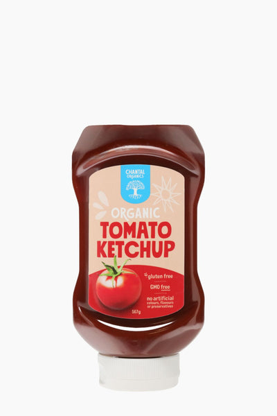 Bottle of organic tomato ketchup with a label on a white background