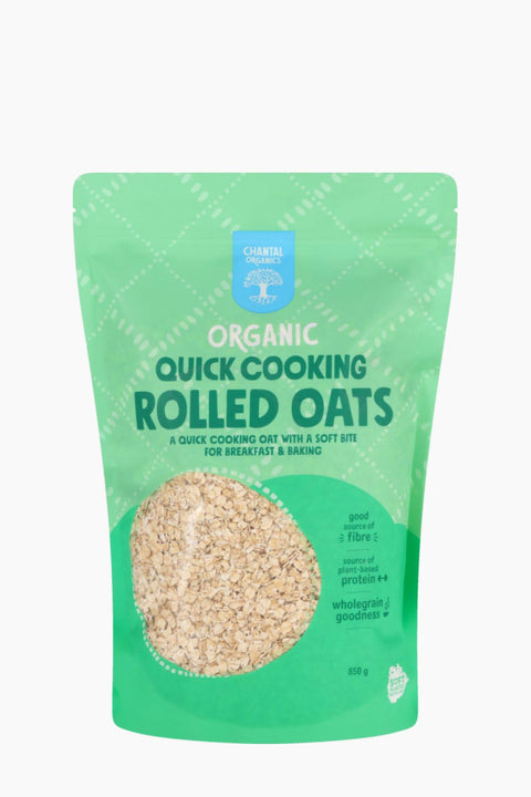 Green package of organic quick cooking rolled oats on a white background
