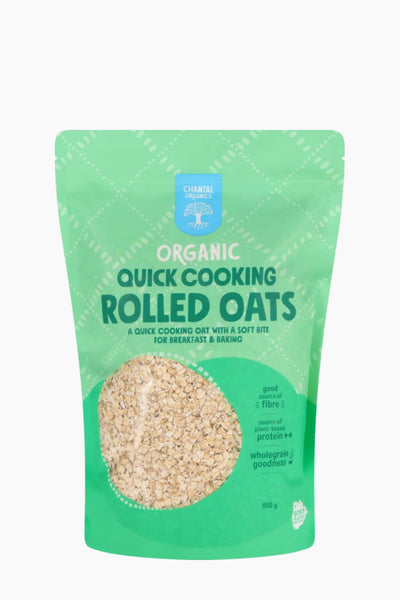 Green package of organic quick cooking rolled oats on a white background