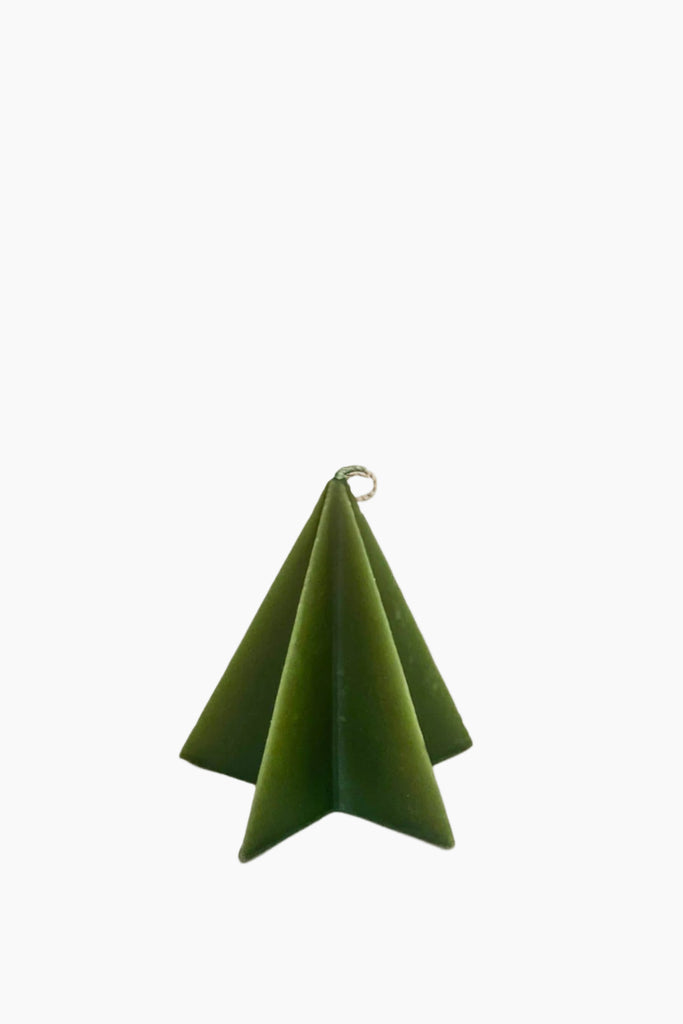 A handcrafted green Christmas tree-shaped candle with a loop for hanging.