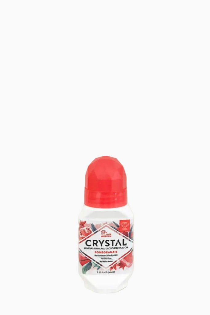 A roll-on deodorant with a white and red container, labeled 'CRYSTAL' with a pomegranate graphic.