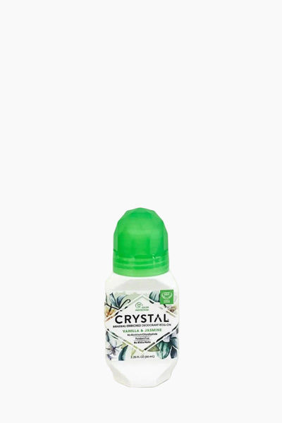 A roll-on deodorant with a green cap labeled 'CRYSTAL' with images of crystals and plants on the label.