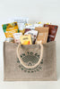 Jute bag filled with organic snacks and products on a white background