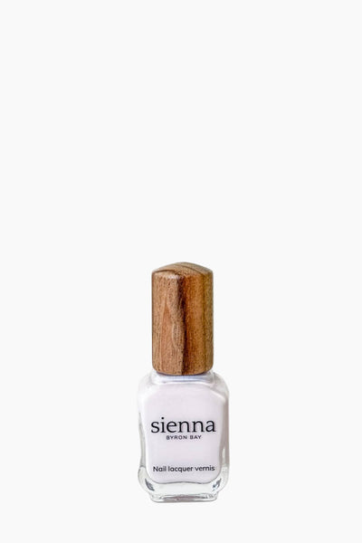 Sienna nail polish bottle with wooden cap on a white background