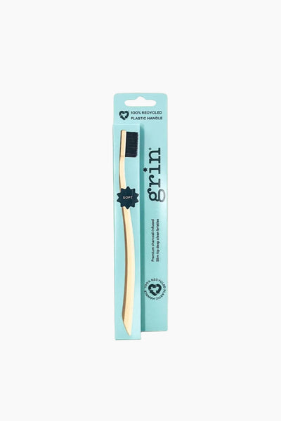 Grin toothbrush with packaging on a white background