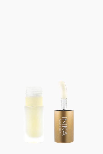 INIKA skincare product with applicator on a beige background