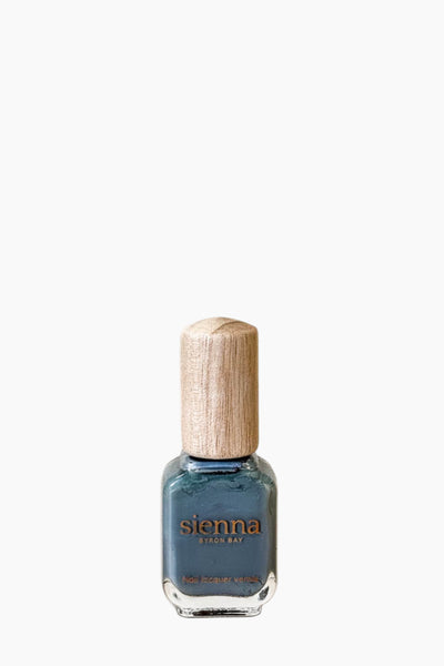 Nail polish bottle with wooden cap on a white background