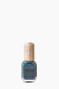 Nail polish bottle with wooden cap on a white background