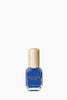 Blue nail polish bottle with gold cap on a white background