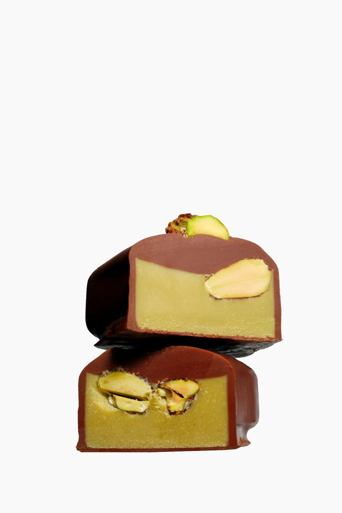 Two layered chocolate dessert with nuts on a white background