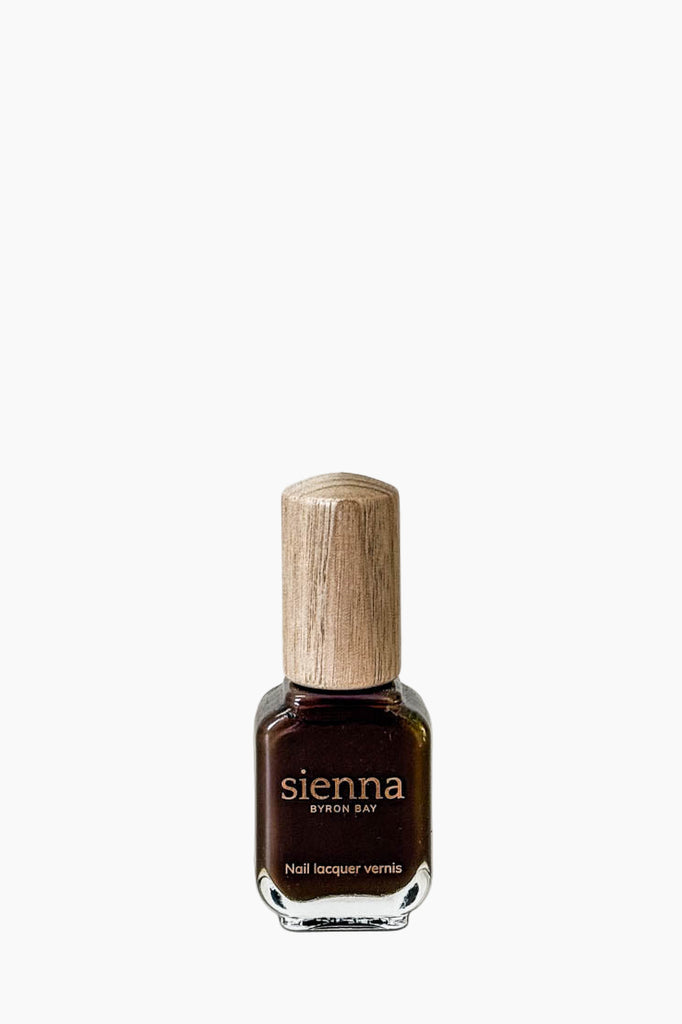 Nail polish bottle with wooden cap on a white background