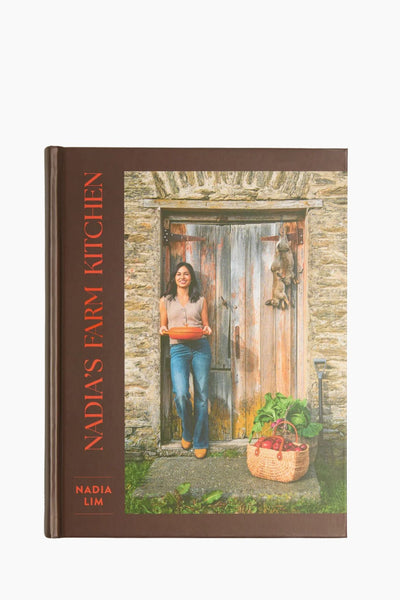 Book cover of 'Nadia's Farm Kitchen' with a woman holding a basket in front of a stone door.