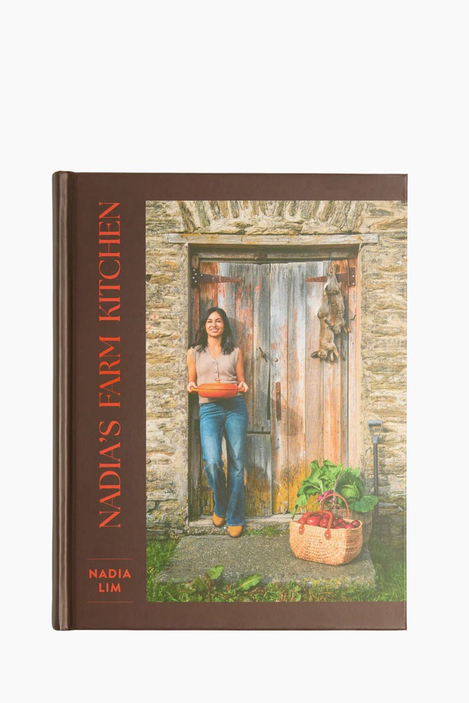 Book cover of 'Nadia's Farm Kitchen' with a woman holding a basket in front of a stone door.