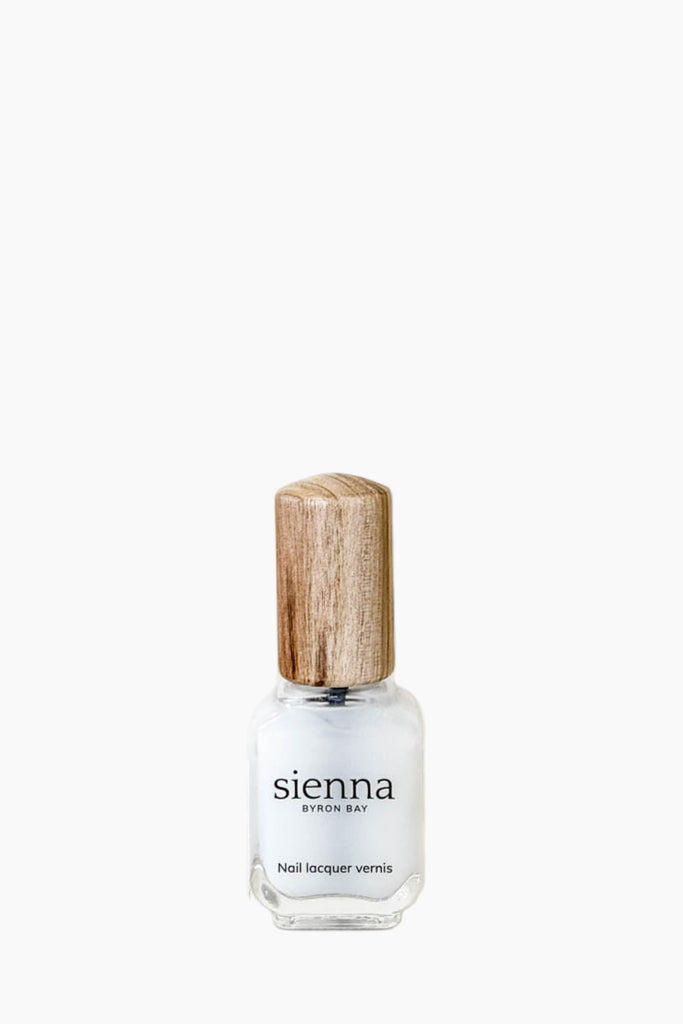 Sienna nail polish bottle with wooden cap on a white background
