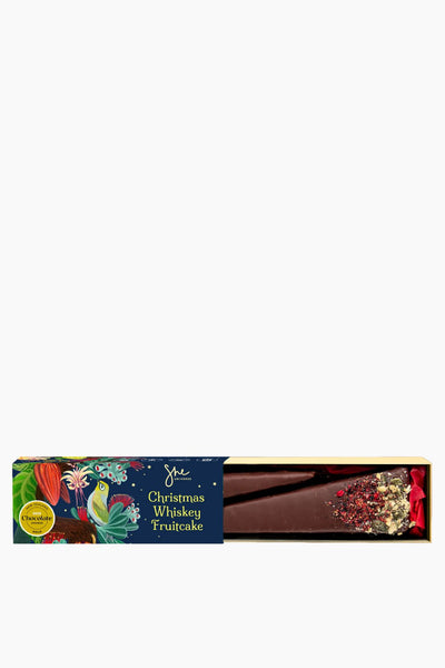 Christmas whiskey fruitcake packaging with colorful design on a white background