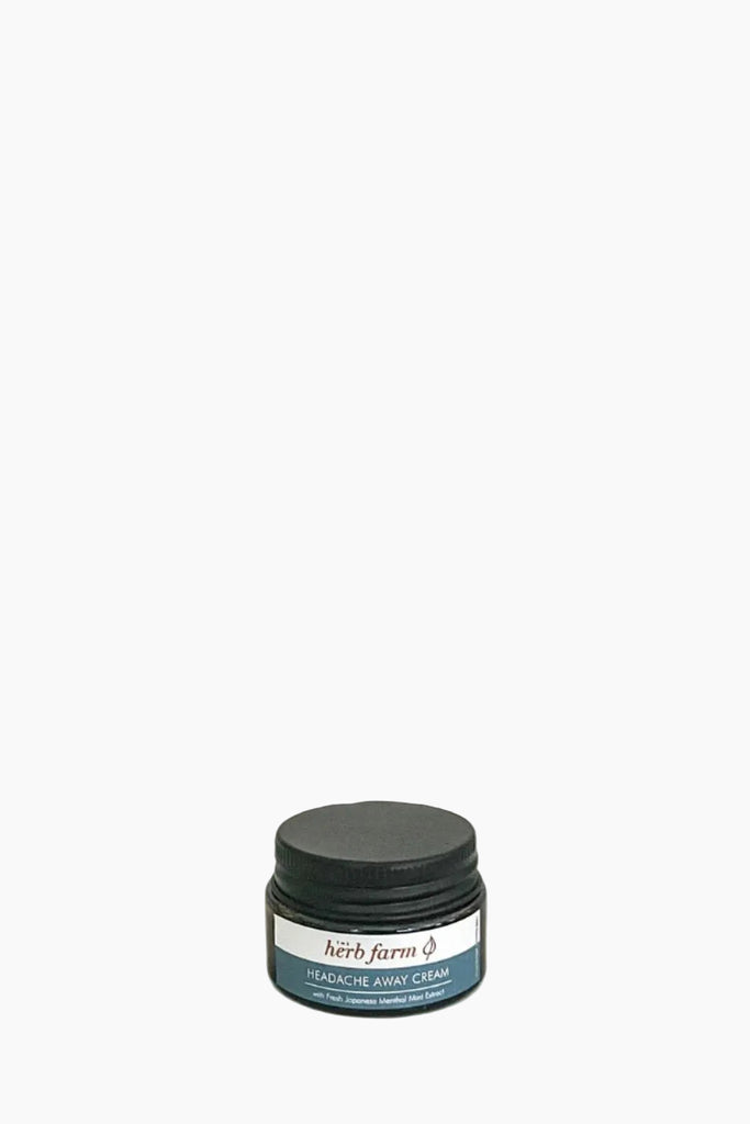 A jar of 'The Herb Farm Headache Away Cream' with a label that includes the product name and the scent marked as peppermint.