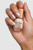 Hand holding a bottle of 'sienna' nail polish with a neutral background